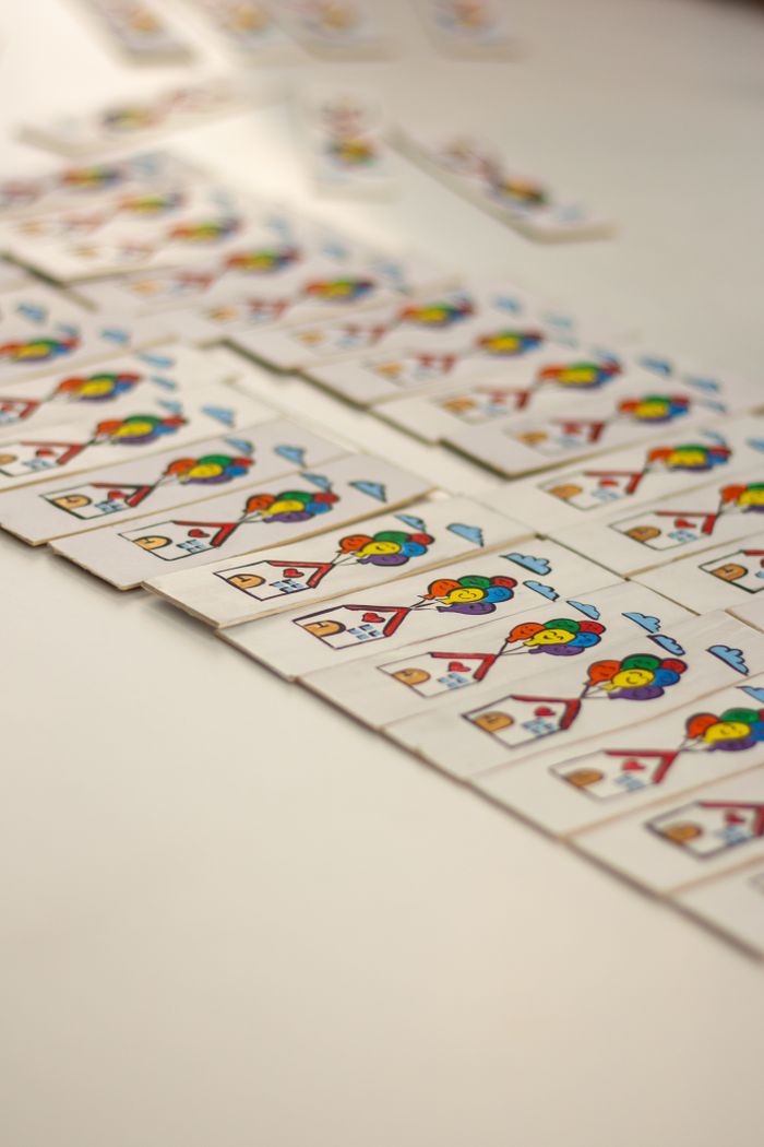 Services A close-up image of colorful playing cards neatly arranged in rows on a smooth surface.